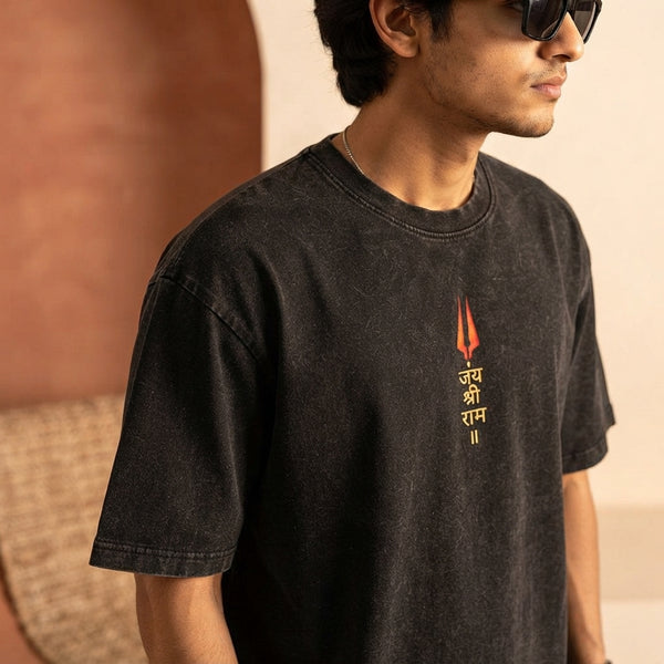 Close-up of a premium charcoal heavyweight cotton oversized t-shirt worn by a South Asian man, highlighting fabric structure.